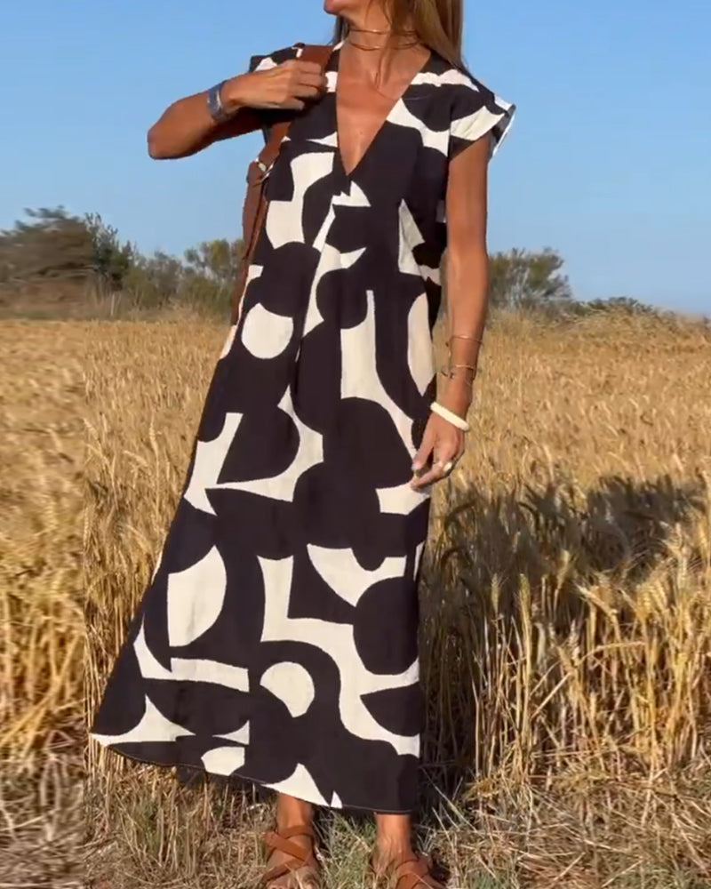 ELVIRA – Gedrukte V-hals jurk met elegante snit en zomerse flair
