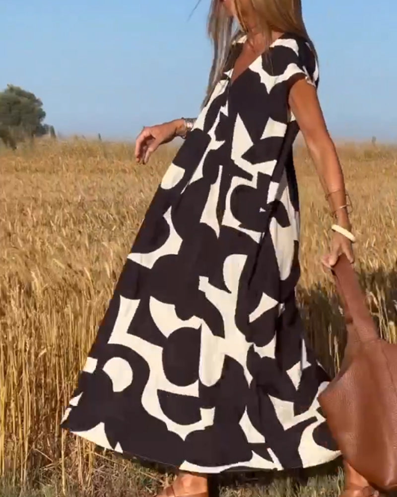 ELVIRA – Gedrukte V-hals jurk met elegante snit en zomerse flair
